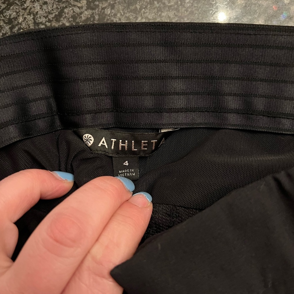 Athleta size 4 black pants. Stretchy. Pull-string cuff, pockets & side zippers. - Picture 3 of 7